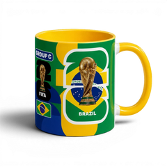 Fann Bliss FIFA World Cup Brazil commemorative ceramic coffee mug with trophy and flag design. Yellow handle and interior.