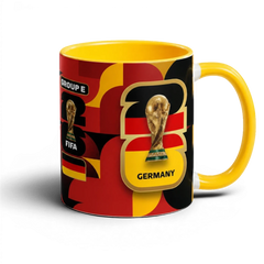 Fann Bliss Germany FIFA World Cup commemorative mug with black, red, yellow geometric design and trophy.