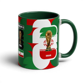 Fann Bliss ceramic coffee mug featuring the Iran flag and FIFA World Cup trophy in green, white, and red colors.