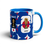 Fann Bliss ceramic coffee mug featuring Japan World Cup branding, FIFA trophy, and blue, white, and red geometric art.