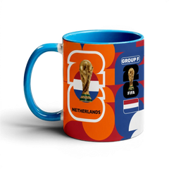 Fann Bliss Netherlands World Cup commemorative ceramic coffee mug with orange, blue, and white abstract pattern, FIFA trophy, and flag.