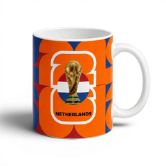 Fann Bliss Netherlands FIFA World Cup commemorative ceramic mug with orange, white, and blue geometric pattern.