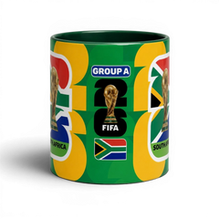 Fann Bliss 2026 FIFA World Cup South Africa ceramic mug with trophy and flag graphics on a green background.