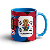 Fann Bliss South Korea World Cup ceramic mug with trophy graphic, blue interior, and red, blue, and black patterns.
