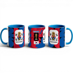 Fann Bliss South Korea World Cup ceramic mug with trophy graphic, blue interior, and geometric red and blue pattern.