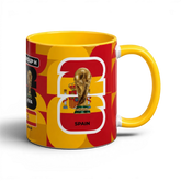 Fann Bliss Spain FIFA World Cup commemorative ceramic mug in red and yellow with trophy and flag design.