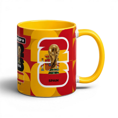 Fann Bliss Spain FIFA World Cup commemorative ceramic mug in red and yellow with trophy and flag design.