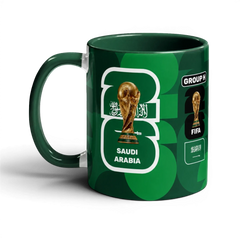 Fann Bliss Saudi Arabia FIFA World Cup 2026 commemorative mug with green geometric pattern, trophy, and national emblem.