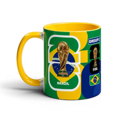 Fann Bliss FIFA World Cup Brazil commemorative ceramic coffee mug with trophy and flag design. Yellow handle.
