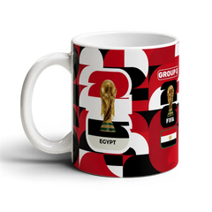 Fann Bliss Egypt World Cup Group G commemorative mug with FIFA trophy and flag graphics in red, black, and white.