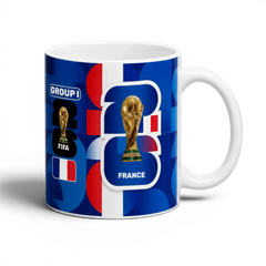 Fann Bliss France FIFA World Cup commemorative ceramic mug with trophy graphic and blue, white, red design.