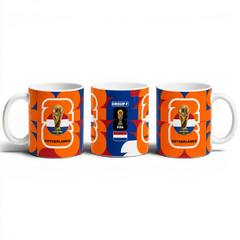 Fann Bliss Netherlands FIFA World Cup commemorative ceramic mug with orange, white, and blue geometric pattern.