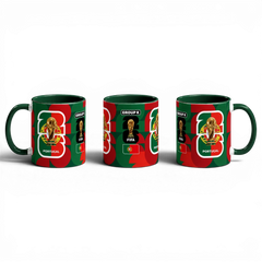 Fann Bliss Portugal FIFA World Cup commemorative ceramic mug with green interior and handle. Features trophy, FIFA logo, Group K, and Portuguese flag.